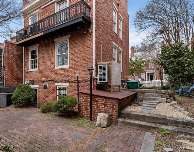 2515 E Grace St, Richmond, VA 23223 - view of property exterior featuring a balcony, fence, and brick siding