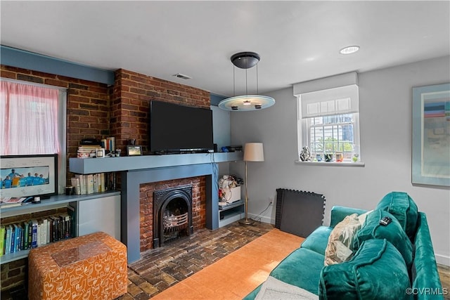 2515 E Grace St, Richmond, VA 23223 - living area featuring visible vents, baseboards, and brick floor