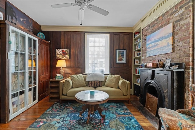 2515 E Grace St, Richmond, VA 23223 - living room featuring wood finished floors, wood walls, and ceiling fan