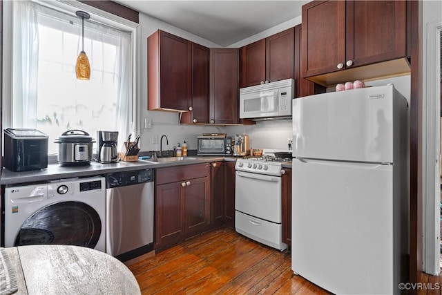 2515 E Grace St, Richmond, VA 23223 - kitchen with white appliances, wood finished floors, washer / clothes dryer, a sink, and dark countertops