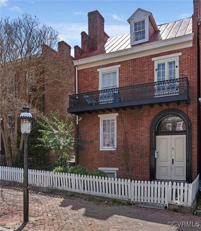 2515 E Grace St, Richmond, VA 23223 - view of front facade featuring a standing seam roof, brick siding, and metal roof