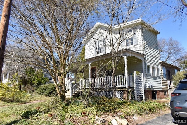 view of front of property featuring stairway and covered porch