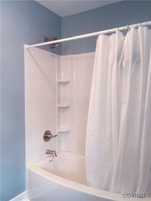 bathroom with shower / bathtub combination with curtain
