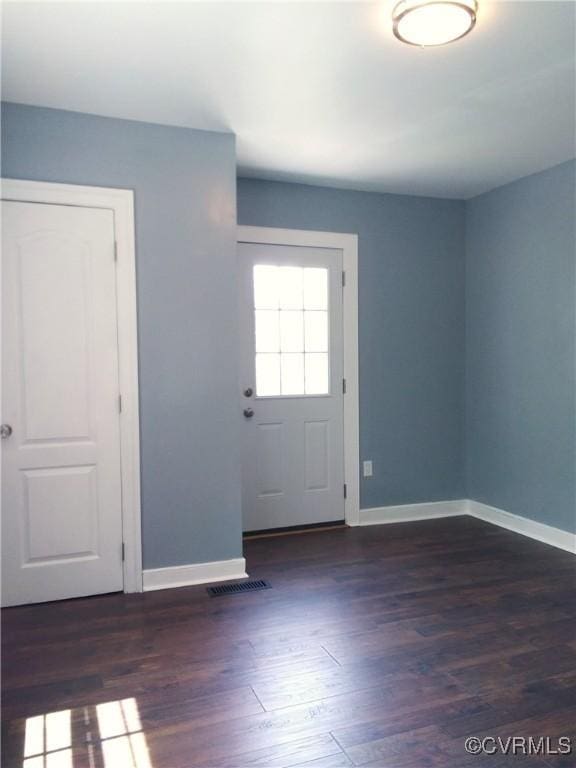 interior space featuring baseboards and wood finished floors