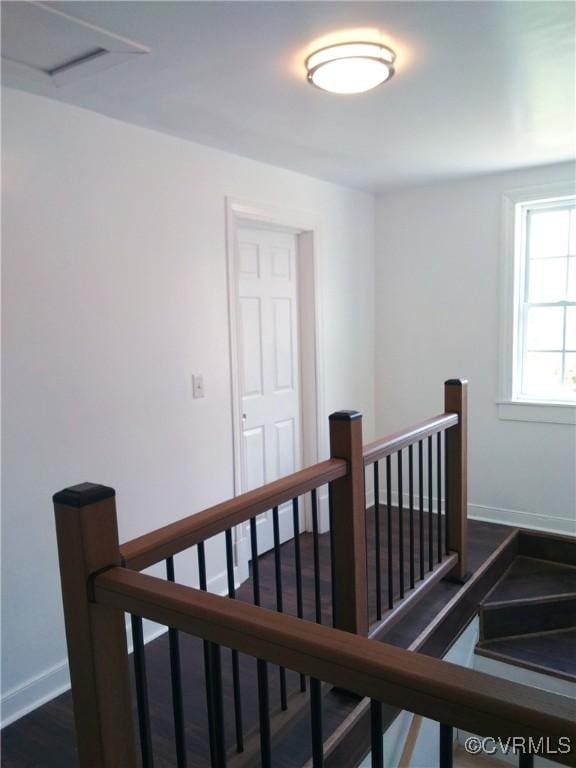 stairs with baseboards and wood finished floors