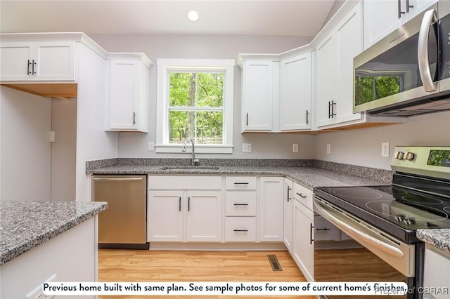 981 Knights Landing Dr, Heathsville, VA 22473 - kitchen featuring stainless steel appliances, white cabinetry, light wood-style floors, recessed lighting, and light stone counters