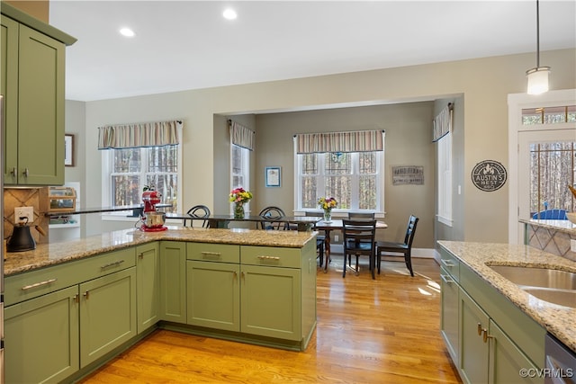 kitchen featuring green cabinets, light wood-style flooring, and a healthy amount of sunlight