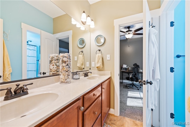 bathroom featuring double vanity, a sink, ceiling fan, and tile patterned floors
