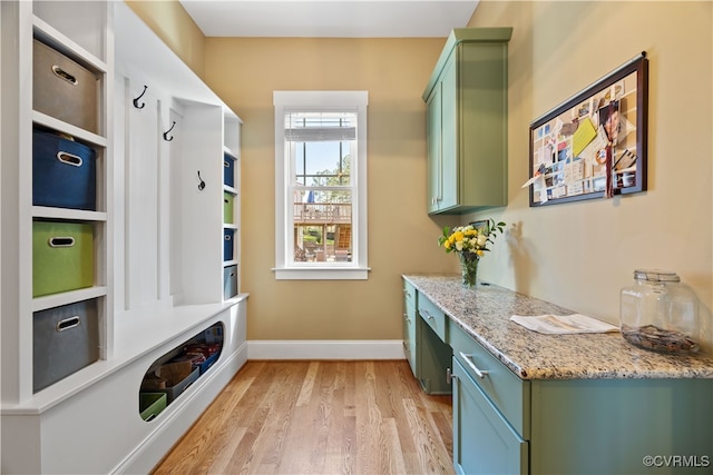 mudroom with baseboards and light wood-type flooring