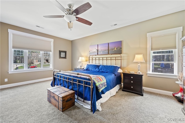 carpeted bedroom with visible vents, ceiling fan, and baseboards