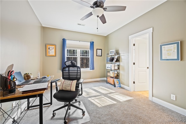 home office featuring visible vents, ceiling fan, light colored carpet, and baseboards