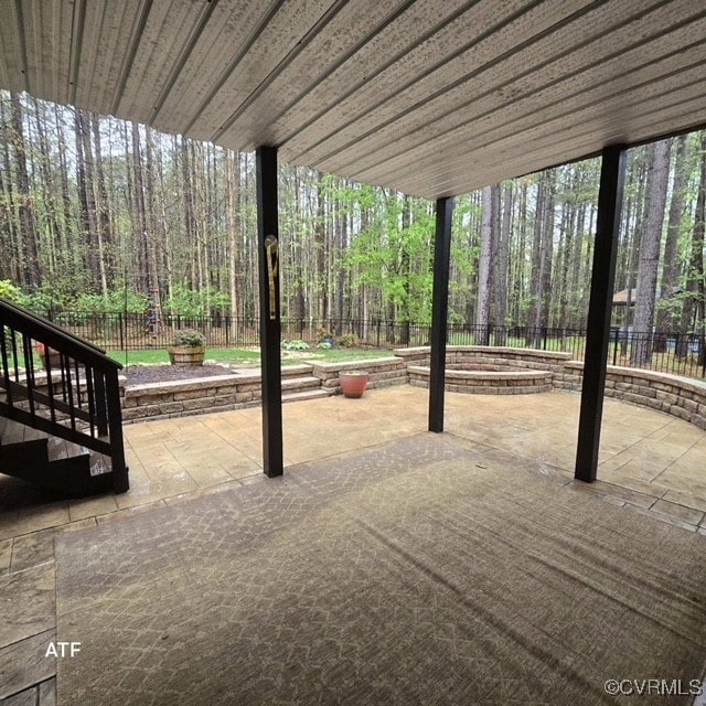 view of patio with a fenced backyard and a wooded view