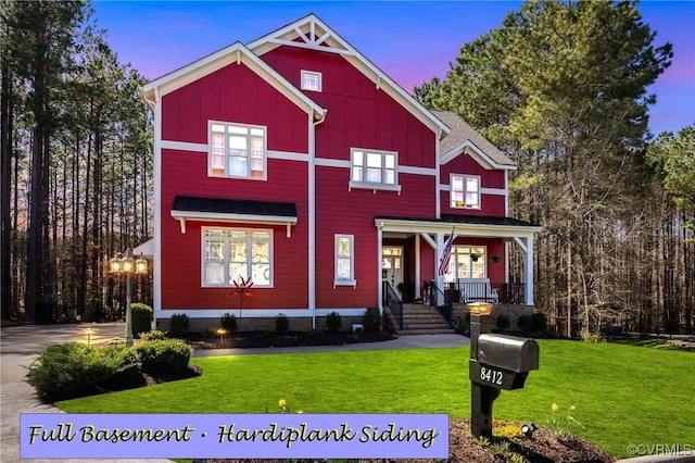 view of front of property featuring covered porch, board and batten siding, and a lawn