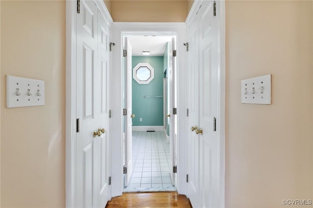 hallway featuring baseboards