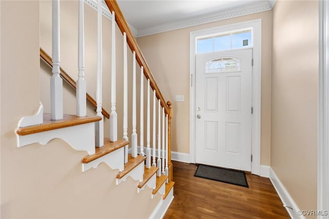 entrance foyer with ornamental molding, baseboards, stairs, and wood finished floors