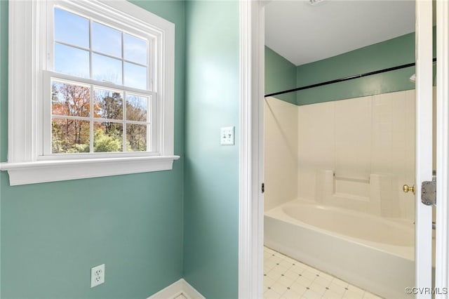 bathroom with tile patterned floors, shower / bathtub combination, and baseboards