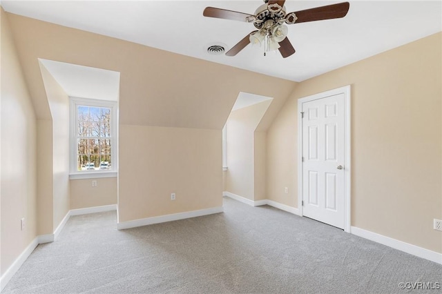 bonus room featuring vaulted ceiling, baseboards, carpet floors, visible vents, and a ceiling fan