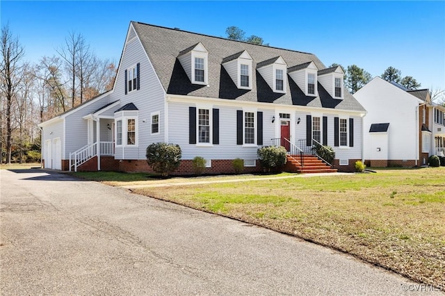 new england style home featuring roof with shingles, crawl space, and a front yard