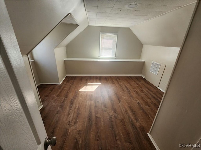 bonus room with visible vents, baseboards, vaulted ceiling, and wood finished floors