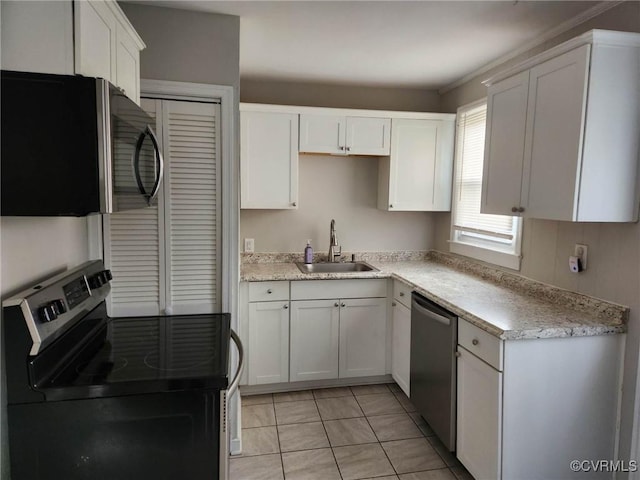 kitchen with a sink, light countertops, white cabinets, and stainless steel appliances