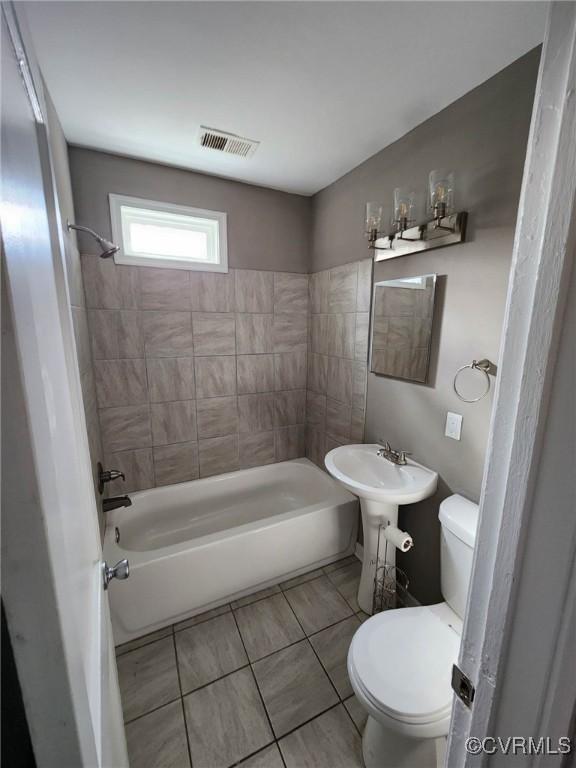 full bathroom with tile patterned flooring, shower / bathtub combination, visible vents, and toilet