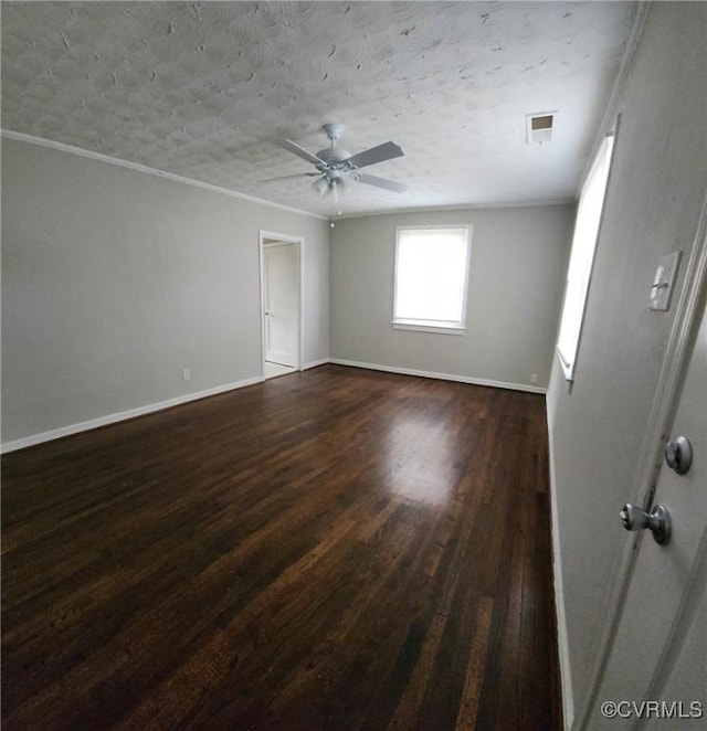 unfurnished room featuring crown molding, baseboards, ceiling fan, and dark wood-type flooring