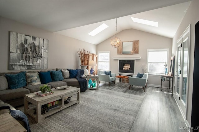 2810 Winterfield Rd, Midlothian, VA 23113 - living room with a skylight, wood finished floors, vaulted ceiling, healthy amount of natural light, and a chandelier