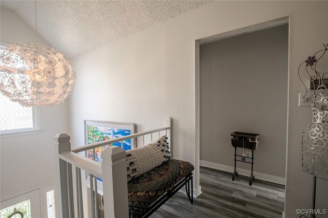 2810 Winterfield Rd, Midlothian, VA 23113 - hallway with wood finished floors, a textured ceiling, lofted ceiling, and an upstairs landing