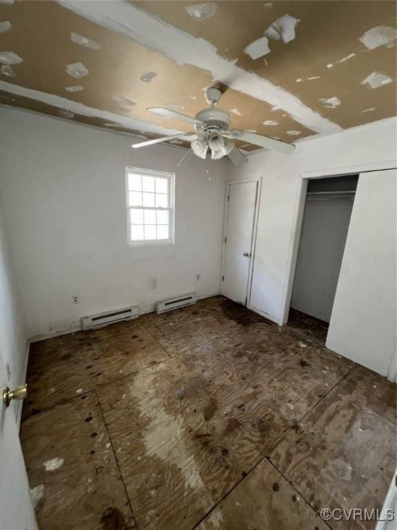 1090 Dry Bread Rd, Emporia, VA 23847 - unfurnished bedroom featuring ceiling fan and a baseboard radiator