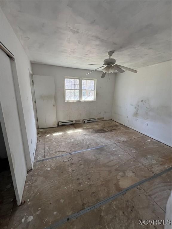 1090 Dry Bread Rd, Emporia, VA 23847 - interior space featuring a ceiling fan and a baseboard heating unit