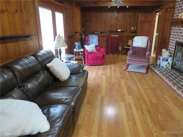 9616 Sunnyside Rd, Mc Kenney, VA 23872 - living room with wooden walls, wood finished floors, ceiling fan, and a brick fireplace