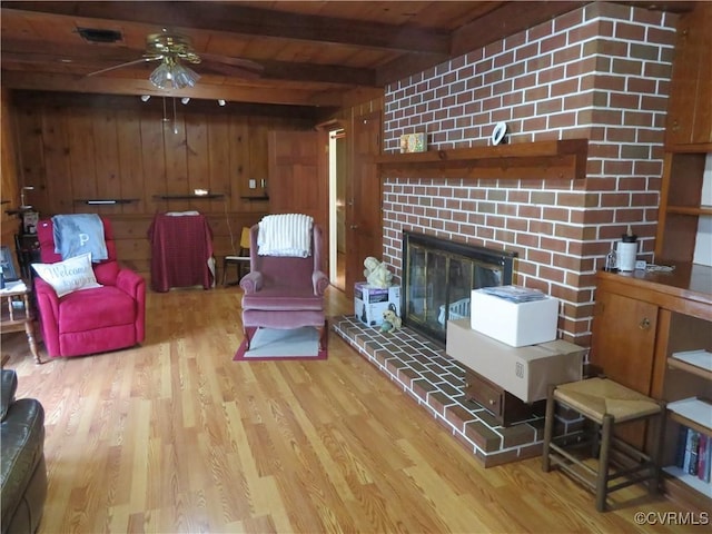 9616 Sunnyside Rd, Mc Kenney, VA 23872 - living area with a ceiling fan, wooden walls, wood finished floors, visible vents, and beamed ceiling