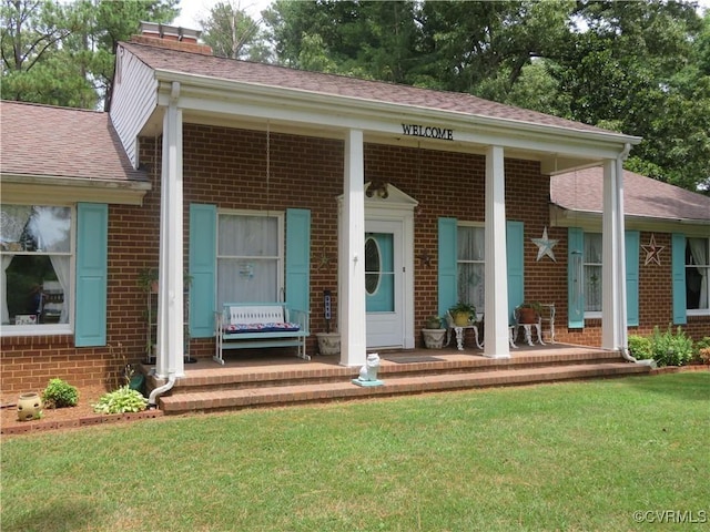 9616 Sunnyside Rd, Mc Kenney, VA 23872 - view of front facade featuring brick siding, a porch, and a front lawn