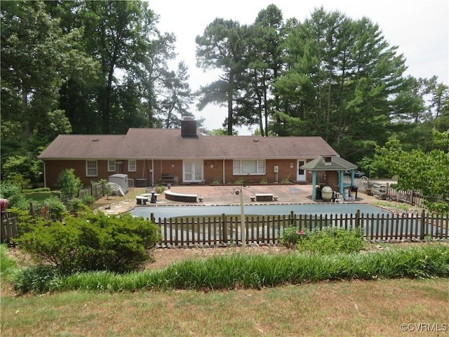 9616 Sunnyside Rd, Mc Kenney, VA 23872 - back of house featuring a chimney, brick siding, fence private yard, and a patio