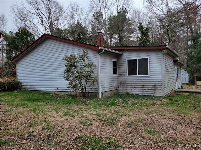 view of home's exterior featuring a chimney
