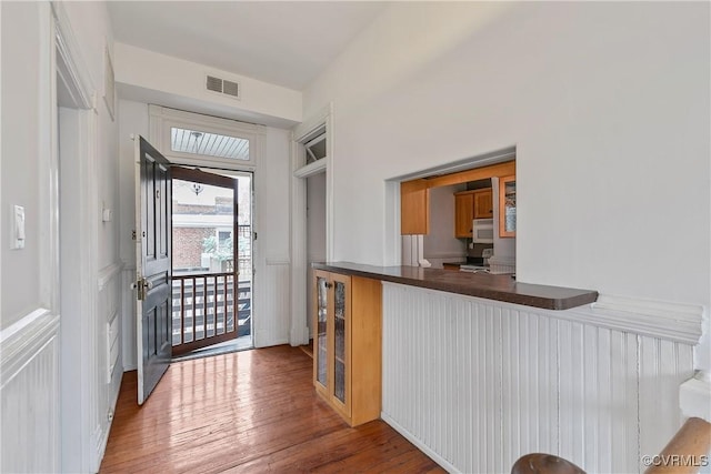 2200 E Grace St, Richmond, VA 23223 - entryway featuring beverage cooler, a wainscoted wall, wood finished floors, visible vents, and a decorative wall