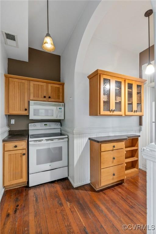 2200 E Grace St, Richmond, VA 23223 - kitchen featuring arched walkways, visible vents, glass insert cabinets, white appliances, and dark wood-type flooring