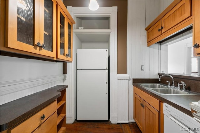 2200 E Grace St, Richmond, VA 23223 - kitchen featuring dark countertops, brown cabinetry, a sink, and white appliances