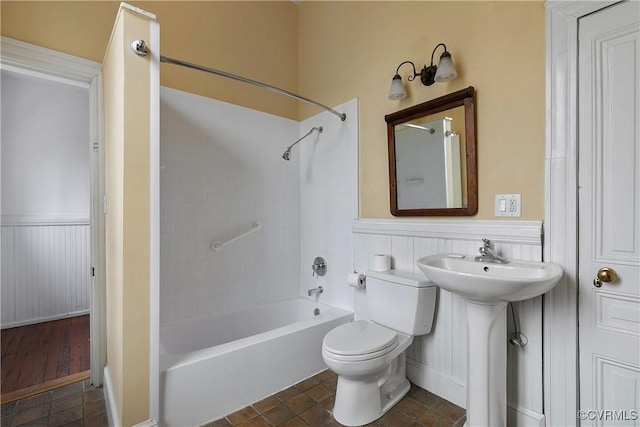 2200 E Grace St, Richmond, VA 23223 - full bath featuring a sink, toilet, shower / tub combination, and wainscoting