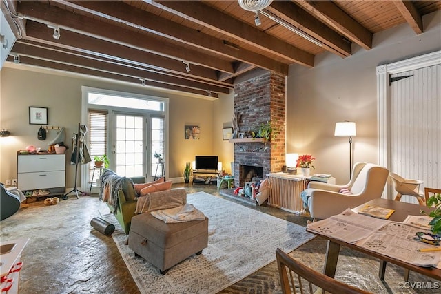 2200 E Grace St, Richmond, VA 23223 - living area featuring beamed ceiling, a brick fireplace, and wood ceiling