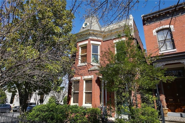 2200 E Grace St, Richmond, VA 23223 - view of property exterior with brick siding and fence