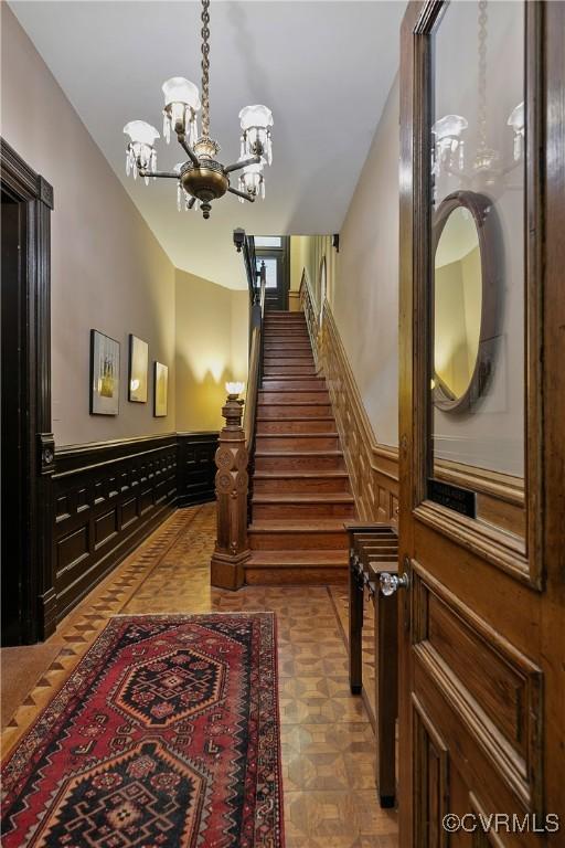 2200 E Grace St, Richmond, VA 23223 - stairway featuring a notable chandelier and a wainscoted wall