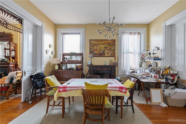 2200 E Grace St, Richmond, VA 23223 - dining room featuring a healthy amount of sunlight, wood finished floors, and a fireplace