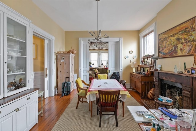 2200 E Grace St, Richmond, VA 23223 - dining space with a fireplace and light wood-style flooring