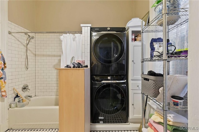 2200 E Grace St, Richmond, VA 23223 - clothes washing area featuring stacked washer / drying machine, tile patterned floors, and laundry area