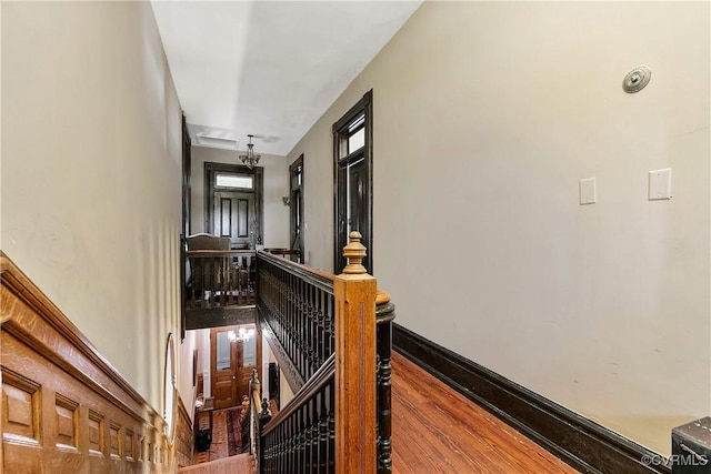 2200 E Grace St, Richmond, VA 23223 - hallway featuring wood finished floors, baseboards, and an upstairs landing