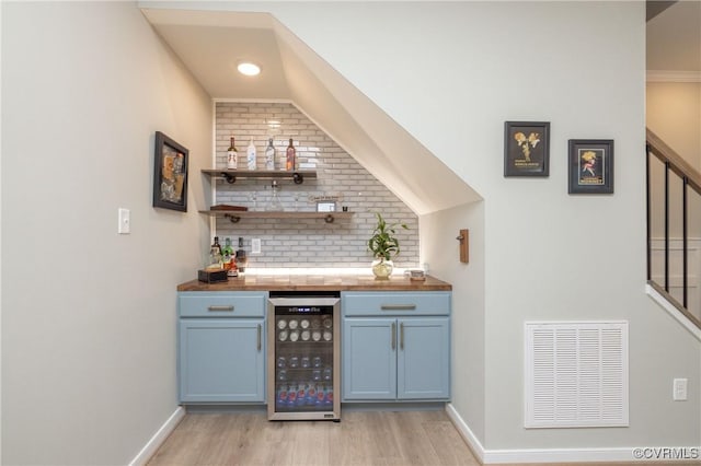 7324 Bailie Dr, Mechanicsville, VA 23111 - bar featuring a bar, beverage cooler, light wood-type flooring, visible vents, and decorative backsplash