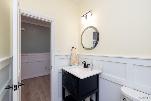 7324 Bailie Dr, Mechanicsville, VA 23111 - bathroom featuring toilet, a wainscoted wall, wood finished floors, and vanity