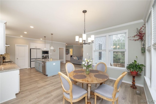 7324 Bailie Dr, Mechanicsville, VA 23111 - dining space with an inviting chandelier, ornamental molding, and light wood-style floors
