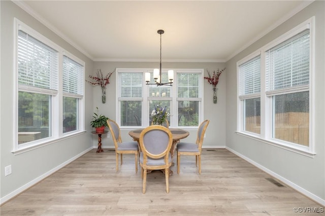 7324 Bailie Dr, Mechanicsville, VA 23111 - dining space featuring crown molding, light wood-style floors, and a notable chandelier